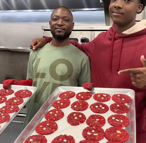 Lil Reggie with his father in the commercial kitchen